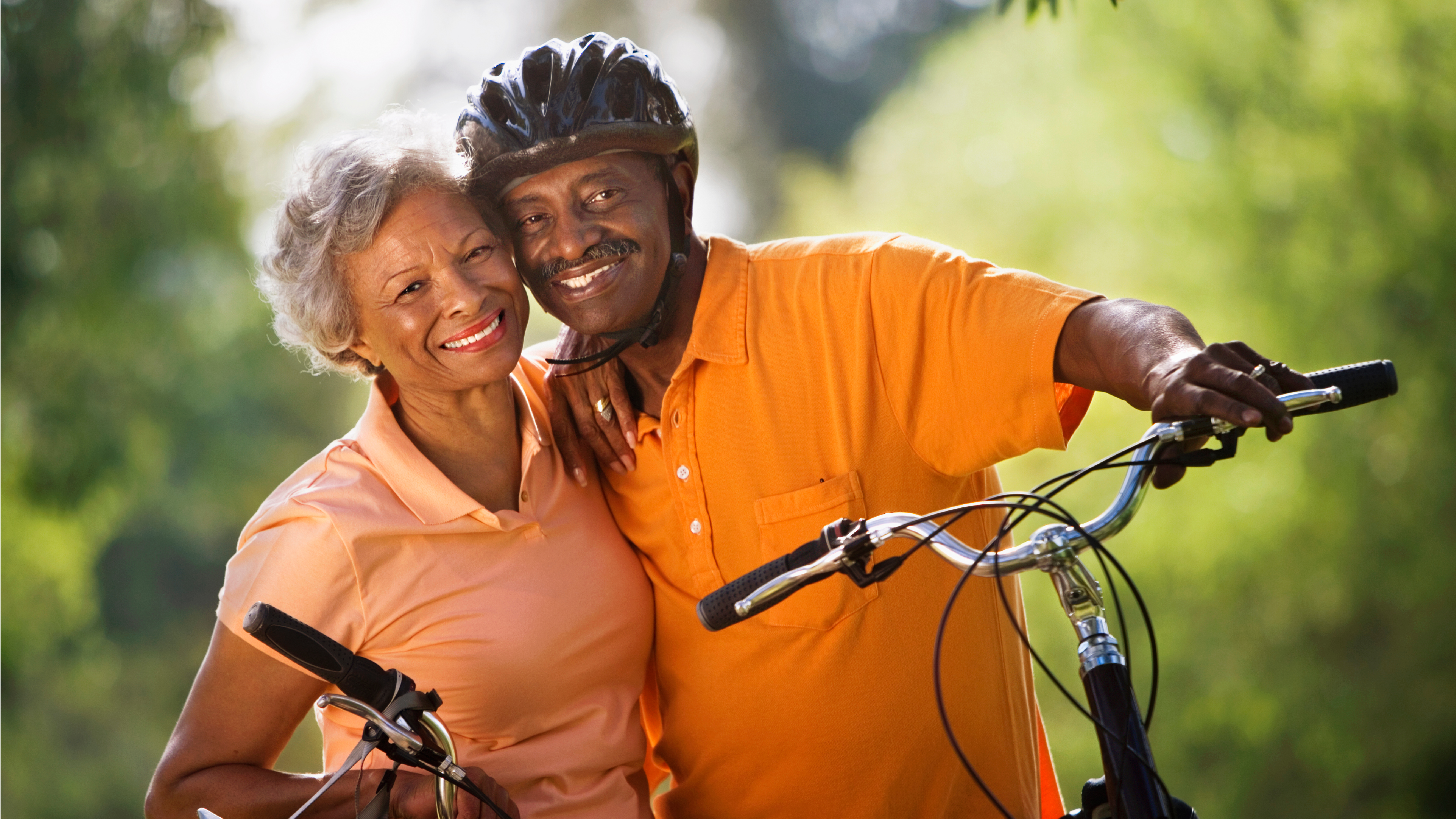 seniors smiling and riding bikes