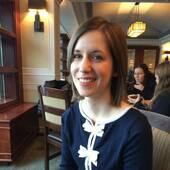 woman in restaurant smiling at camera